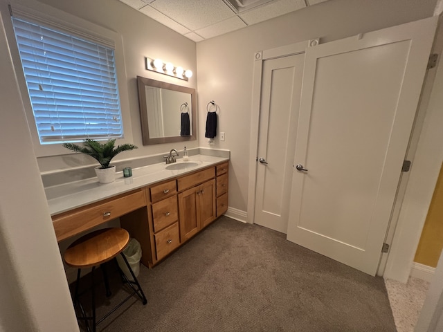 bathroom featuring vanity and a drop ceiling