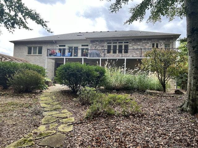 rear view of property featuring a balcony