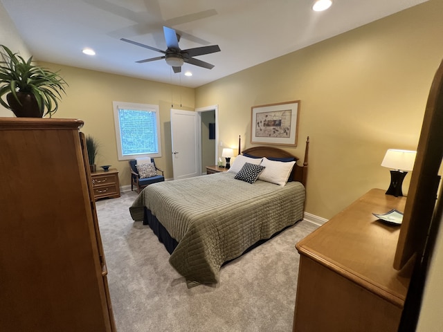 bedroom with ceiling fan and light colored carpet