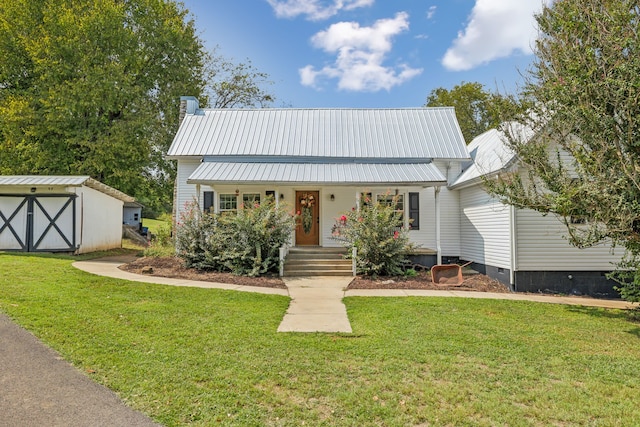 view of front of property featuring a storage unit and a front lawn