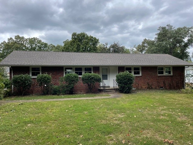 ranch-style house with a front lawn