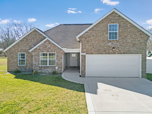 view of front of property with a front yard and a garage