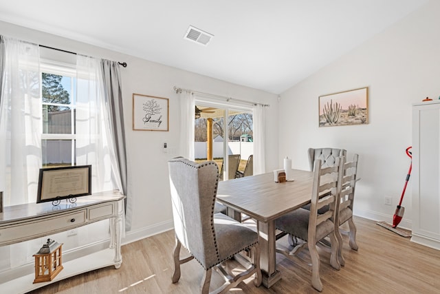 dining area with lofted ceiling and light hardwood / wood-style floors