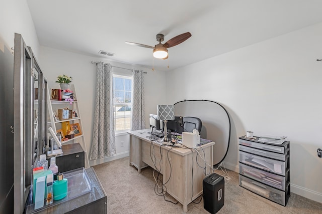 carpeted office space with ceiling fan