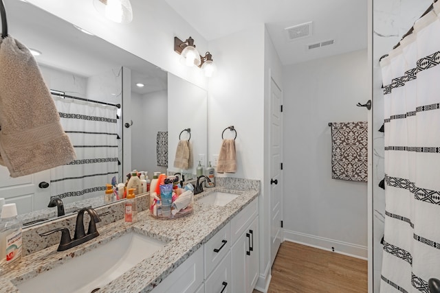 bathroom with vanity and hardwood / wood-style floors