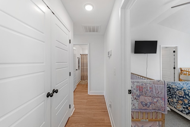 corridor with light wood-type flooring