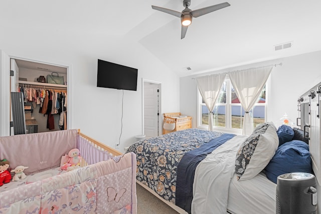 bedroom with vaulted ceiling, a closet, carpet, a spacious closet, and ceiling fan