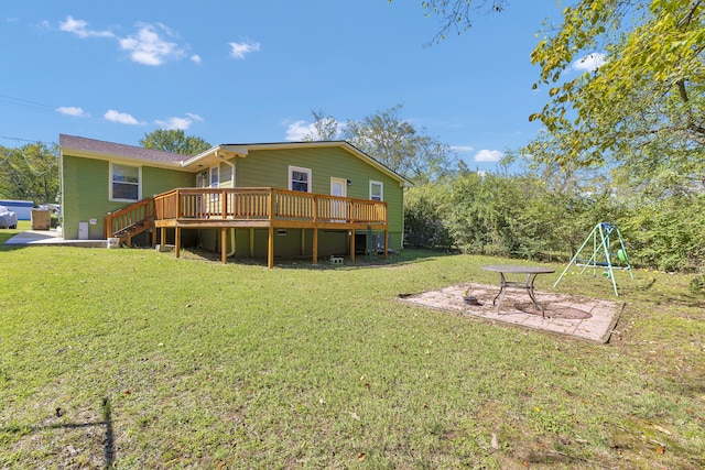 rear view of property with a yard and a deck