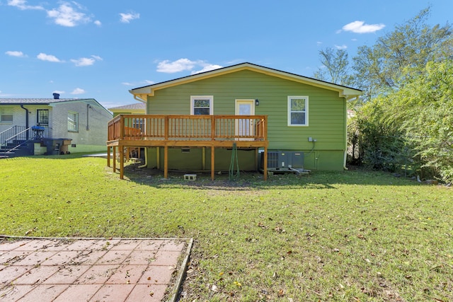 back of house featuring a deck and a lawn