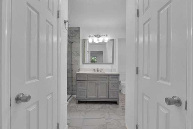 bathroom featuring walk in shower, vanity, and toilet