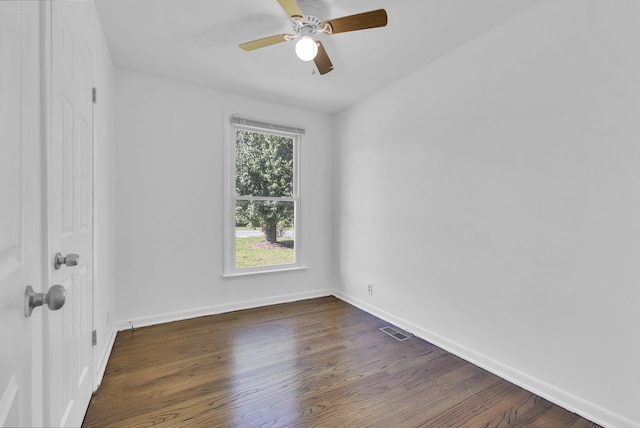 spare room featuring dark wood-type flooring and ceiling fan