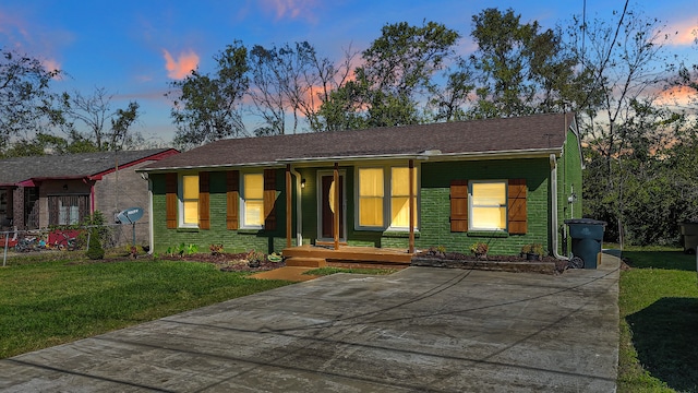 ranch-style house featuring a yard and covered porch