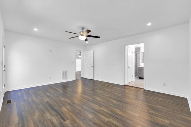 empty room with ceiling fan and dark hardwood / wood-style floors