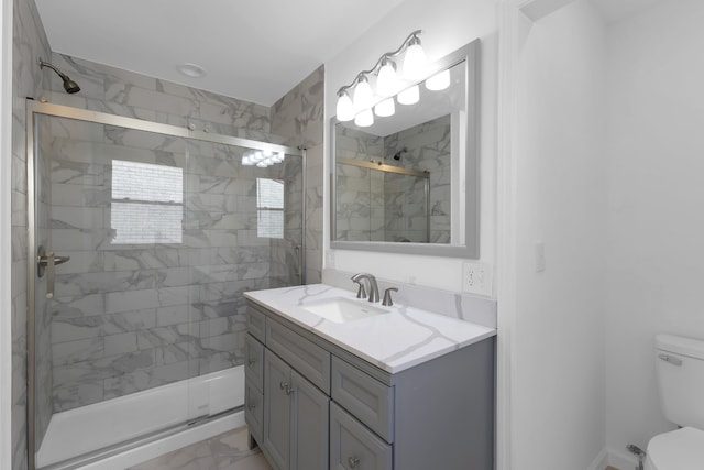 bathroom with vanity, walk in shower, and toilet