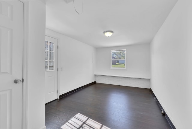 unfurnished room featuring dark hardwood / wood-style flooring