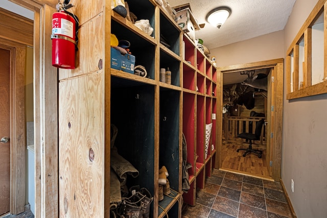 mudroom featuring a textured ceiling