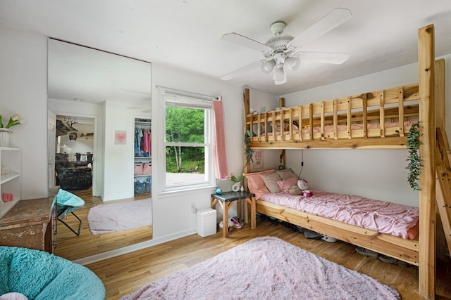 bedroom with ceiling fan, a closet, and hardwood / wood-style floors