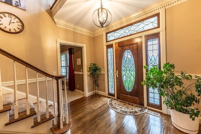 233 Nine Mile Cross Rd W, Pikeville, TN 37367 - foyer featuring an inviting chandelier, ornamental molding, stairs, hardwood / wood-style floors, and baseboards