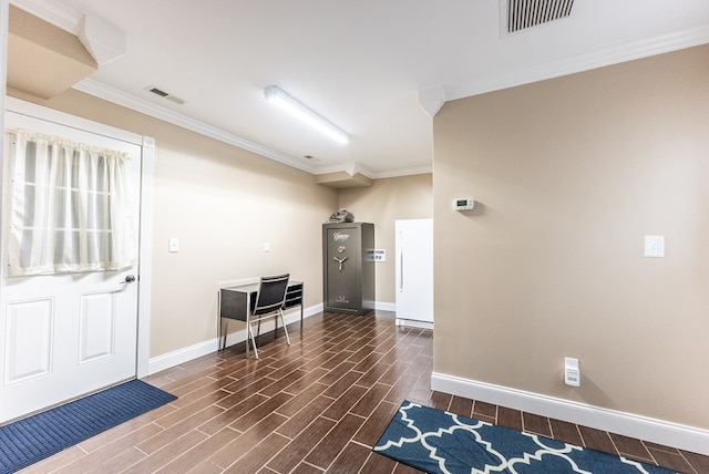 entrance foyer with ornamental molding and dark wood-type flooring