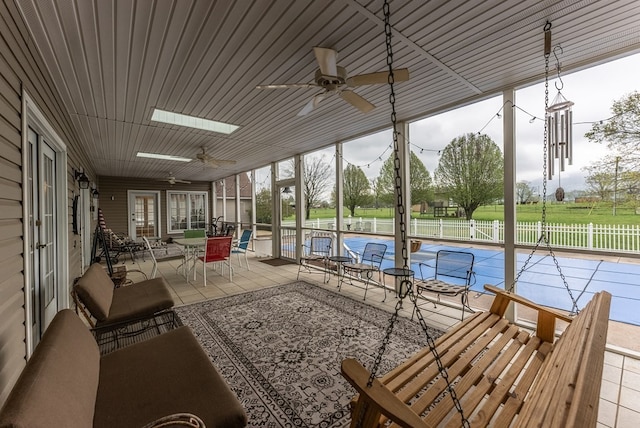 exterior space with ceiling fan and a skylight