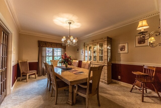 carpeted dining area featuring a chandelier and crown molding