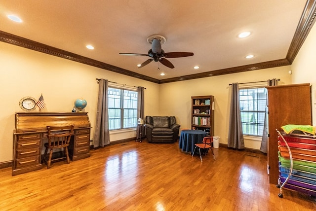 sitting room featuring ceiling fan, wood-type flooring, and ornamental molding