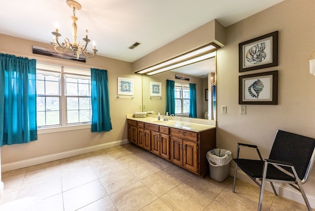 bathroom with vanity, a notable chandelier, and tile patterned flooring