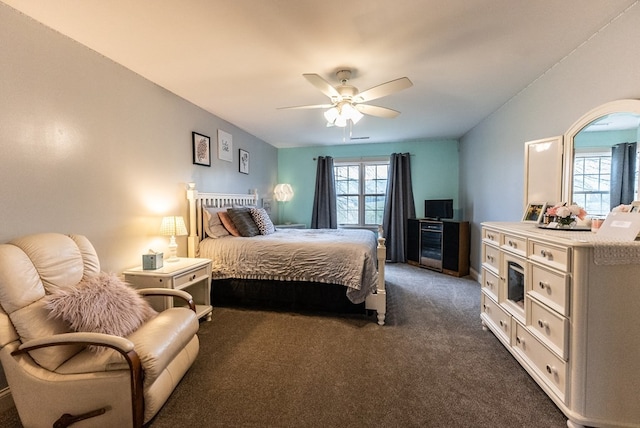 bedroom with dark carpet, multiple windows, and ceiling fan