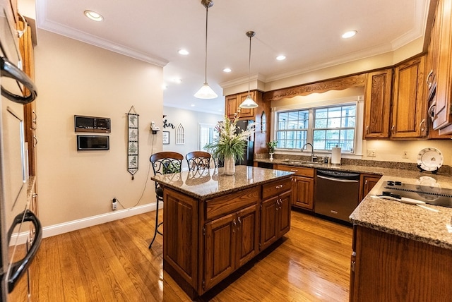 kitchen with a kitchen island, sink, light hardwood / wood-style flooring, and dishwasher