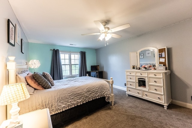 bedroom with ceiling fan and dark colored carpet