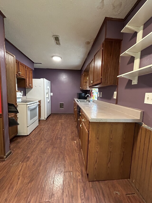 kitchen featuring a textured ceiling, dark hardwood / wood-style flooring, white appliances, and sink