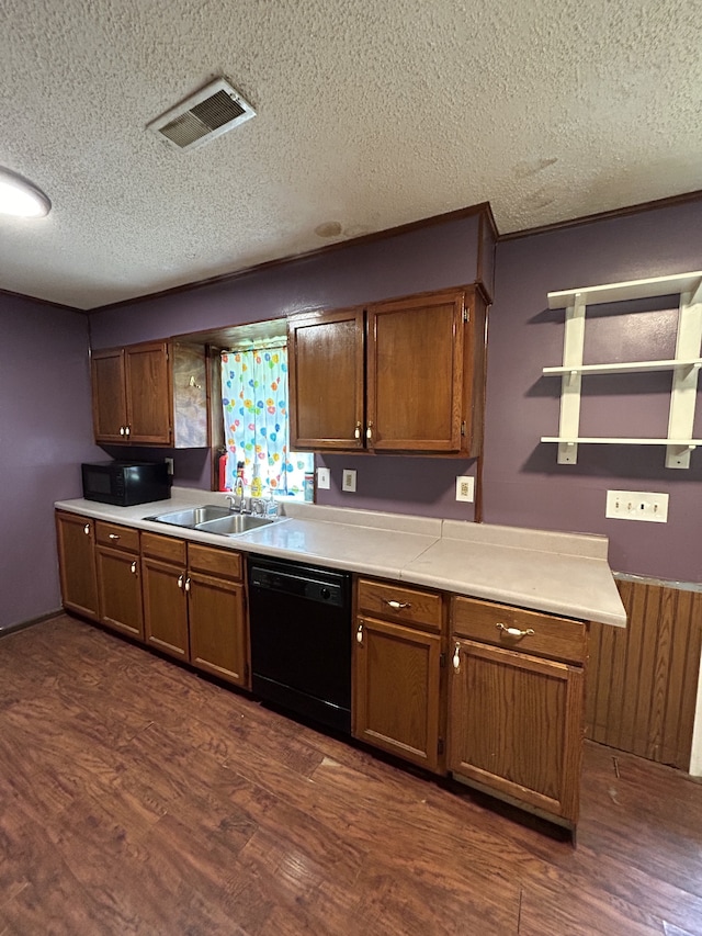 kitchen with a textured ceiling, sink, black appliances, and dark hardwood / wood-style floors