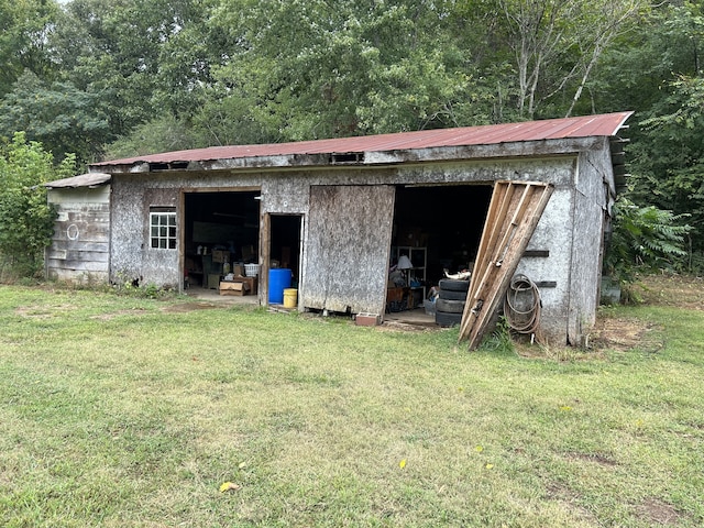 view of outbuilding with a yard