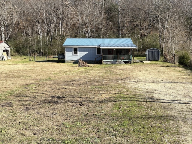 view of outdoor structure featuring a lawn and covered porch