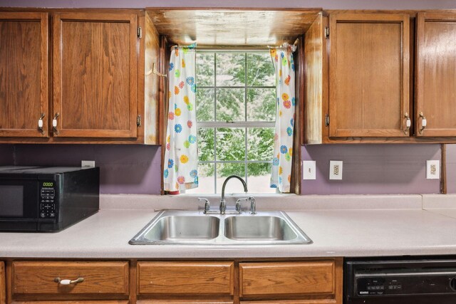 163 Longbranch Rd, Hohenwald, TN 38462 - kitchen featuring black appliances, a sink, light countertops, and brown cabinetry
