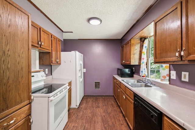 163 Longbranch Rd, Hohenwald, TN 38462 - kitchen featuring black appliances, a sink, a textured ceiling, brown cabinets, and dark wood finished floors
