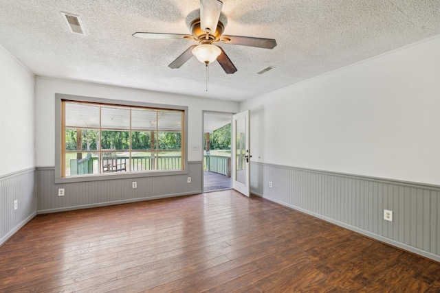 163 Longbranch Rd, Hohenwald, TN 38462 - spare room featuring hardwood / wood-style floors, a wainscoted wall, a textured ceiling, and a ceiling fan