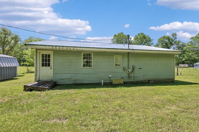 163 Longbranch Rd, Hohenwald, TN 38462 - back of house with a lawn, an outdoor structure, and metal roof
