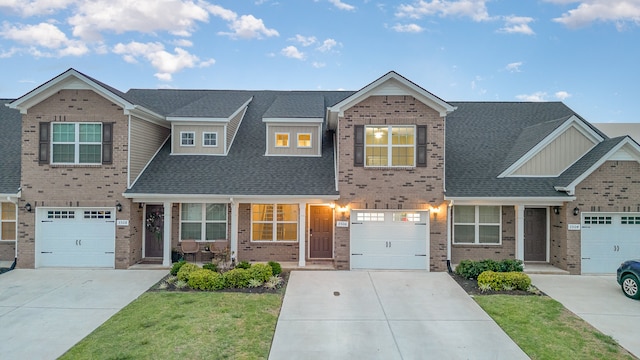 multi unit property with a front yard and a garage