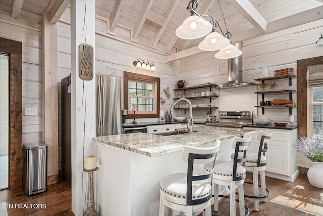 kitchen featuring dark stone counters, pendant lighting, dark hardwood / wood-style flooring, and stainless steel electric range oven