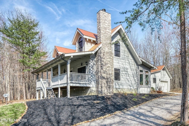 view of side of home featuring a garage and a porch