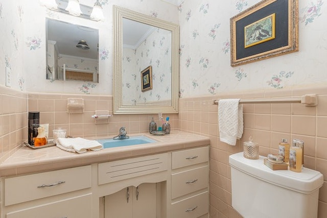 bathroom featuring tile walls, toilet, tasteful backsplash, and vanity