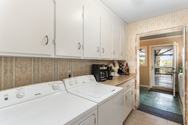 laundry room with cabinets, washer and clothes dryer, and ornamental molding