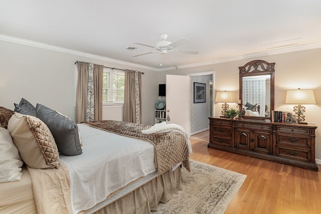 bedroom featuring light wood-type flooring, ornamental molding, and ceiling fan