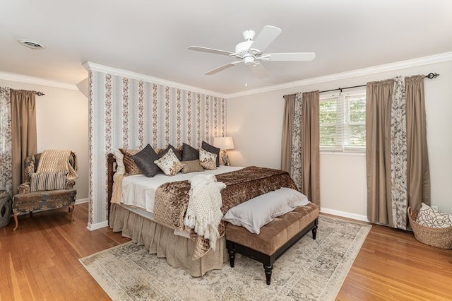 bedroom with crown molding, wood-type flooring, and ceiling fan