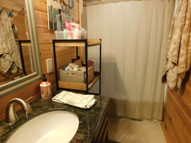 bathroom with wood walls and vanity