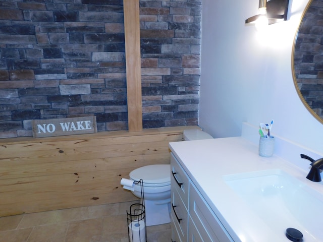 bathroom featuring tile patterned flooring, vanity, and toilet