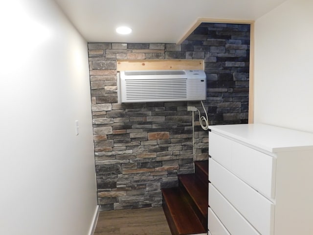 bathroom featuring a wall unit AC and hardwood / wood-style flooring