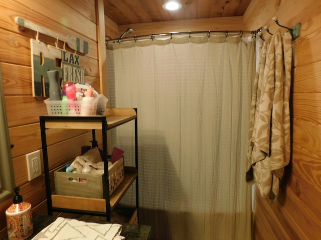 bathroom with wood walls and wooden ceiling