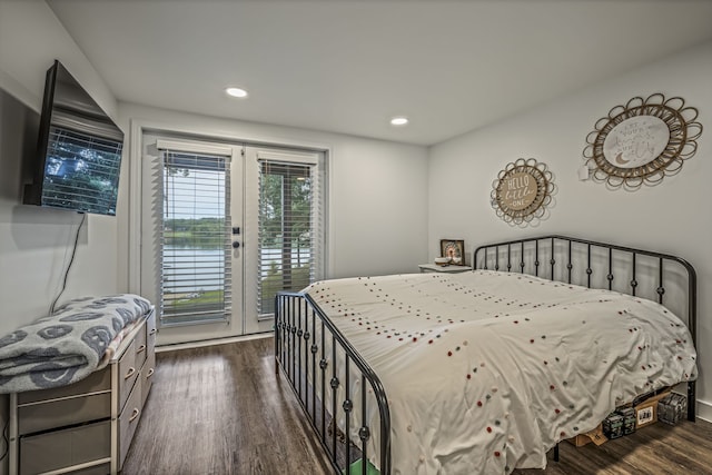 bedroom featuring access to exterior and dark wood-type flooring